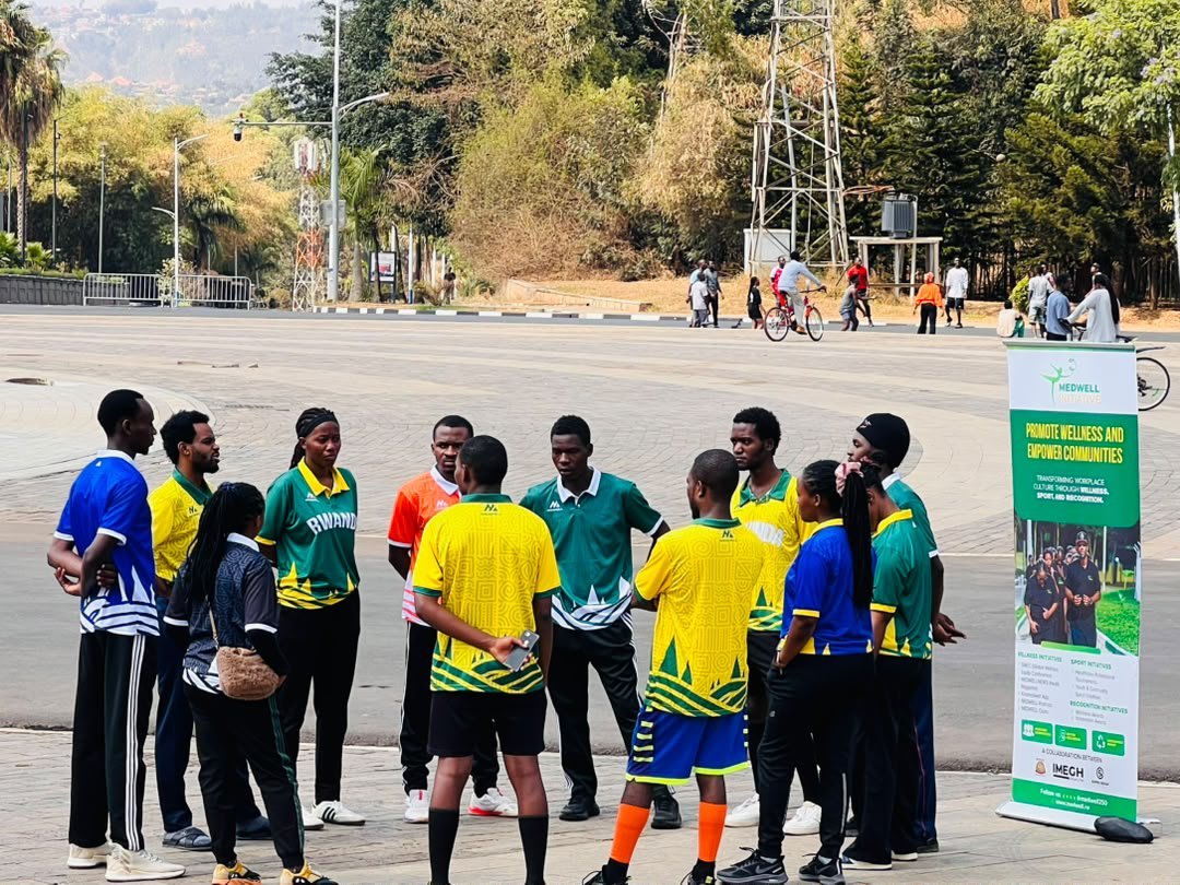 MedWell Club members standing in a circle for a reflection session beside the MedWell banner after the Car Free Day mass sport.
