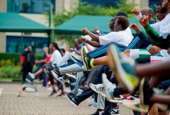 Close view of participants stretching together in a row at Car Free Day.